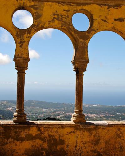 Gorgeous ocean view through vintage arches at Sintra Palace, Portugal.