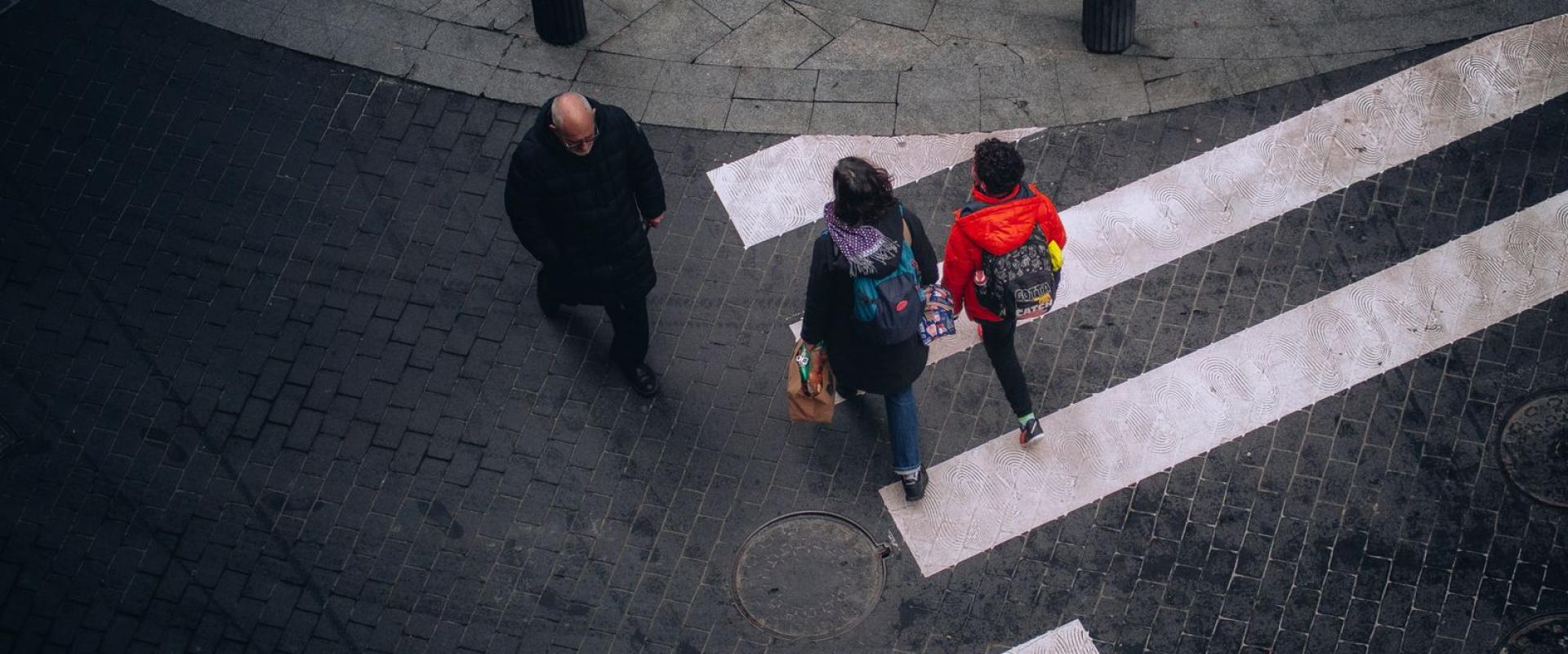 High-angle view of people crossing a street in Bilbao, Spain, showcasing urban life.