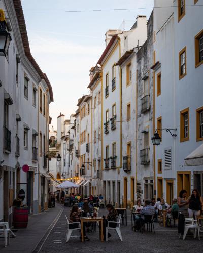 Discover the vibrant street life and historic architecture of Évora, Portugal's charming alleyway.