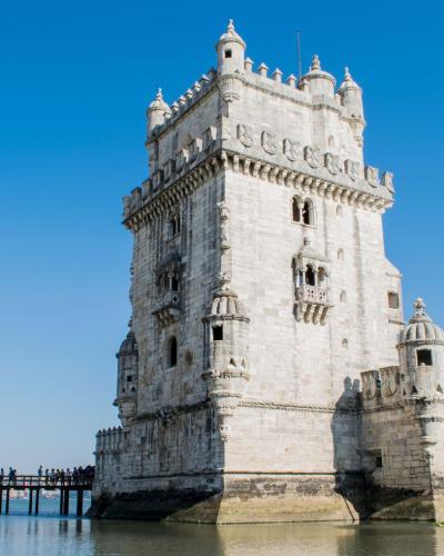 Capture of the historic Belem Tower against a clear blue sky in Lisbon, Portugal.