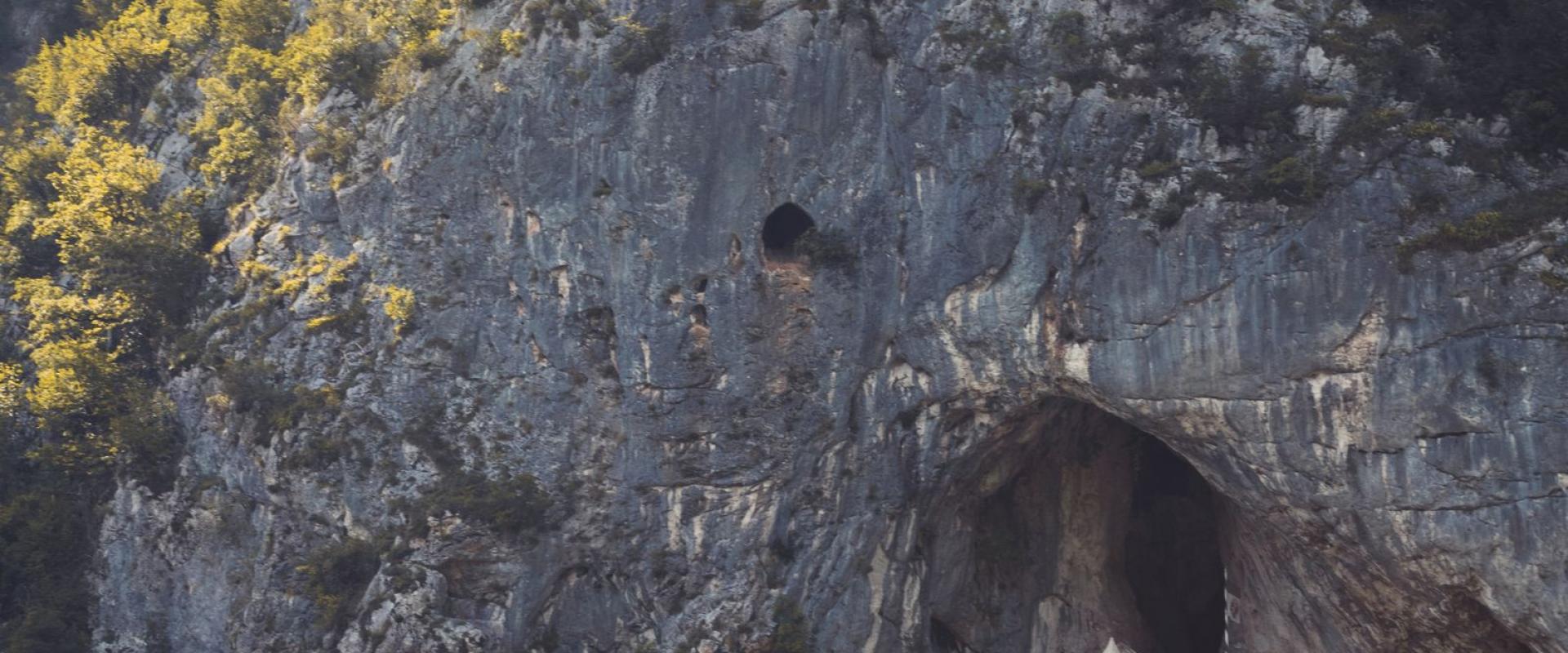 Free Explore the historical Predjama Castle in Slovenia, emerging from a natural cave within a rugged cliff. Stock Photo
