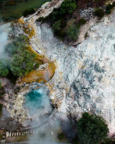 Steaming geothermal springs and turquoise pool at Furnas, Sao Miguel, Azores