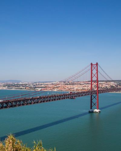 The red 25 de Abril suspension bridge spanning the Tagus River in Lisbon