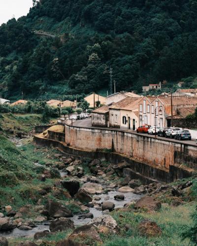 Village and green hills near the Salto do Prego hiking trail, Sao Miguel, Azores