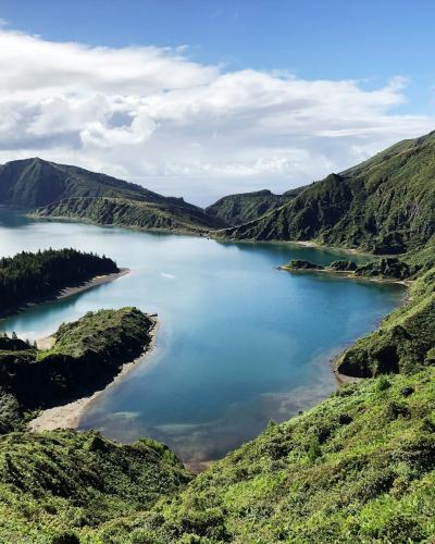 Lagoa do Fogo crater lake surrounded by emerald green hills on Sao Miguel, Azores