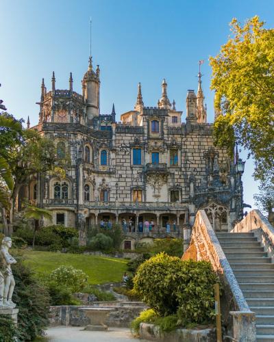 Quinta da Regaleira palace rising above its lush gardens in Sintra, Portugal