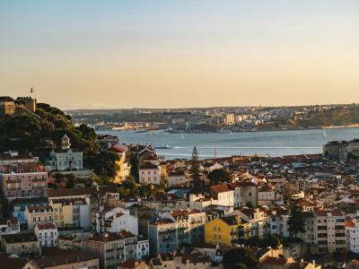 Sunset view over Lisbon's rooftops and the Tagus from Miradouro da Senhora do Monte