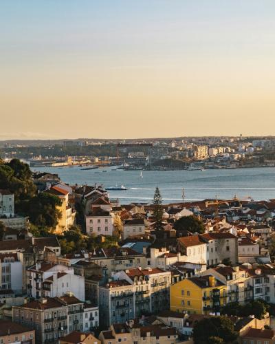 Sunset view over Lisbon's rooftops and the Tagus from Miradouro da Senhora do Monte