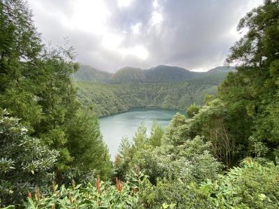 Deep crater lake ringed by steep green slopes in the Azores