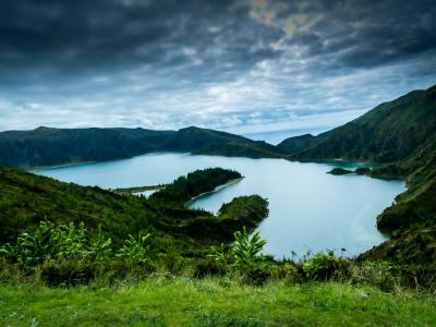 Crater lake ringed by green volcanic slopes on Sao Miguel island, Azores, Portugal