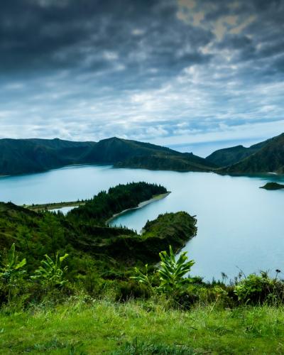 Crater lake ringed by green volcanic slopes on Sao Miguel island, Azores, Portugal