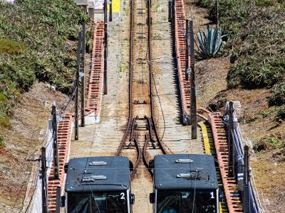 Cars of the Ascensor da Nazaré funicular on the slope between the beach and Sítio