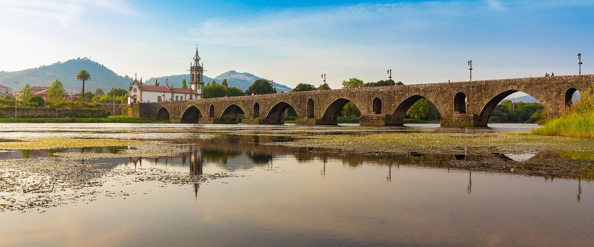 The medieval bridge of Ponte de Lima reflected in the Lima River, Minho