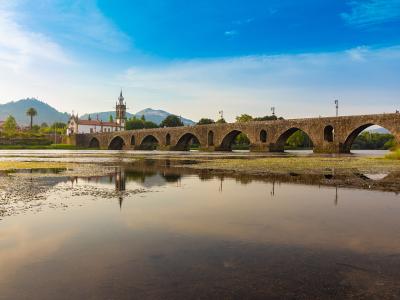 The medieval bridge of Ponte de Lima reflected in the Lima River, Minho