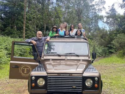 Tour group with a Land Rover jeep on a forest track during a Madeira jeep tour