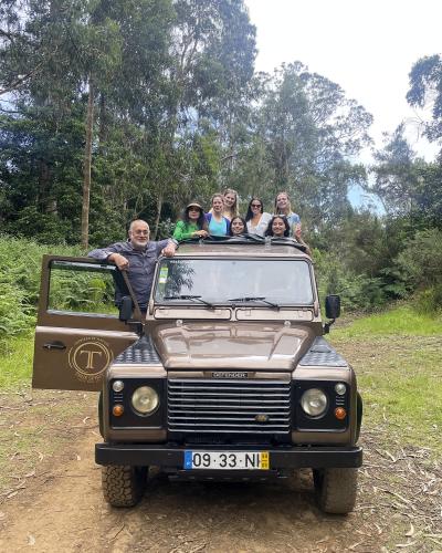 Tour group with a Land Rover jeep on a forest track during a Madeira jeep tour
