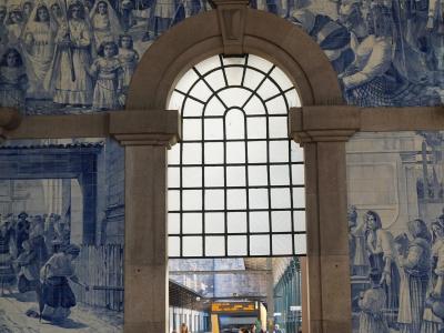 Azulejo-lined hall of Sao Bento station in Porto with a view to the train platforms