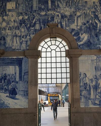 Azulejo-lined hall of Sao Bento station in Porto with a view to the train platforms