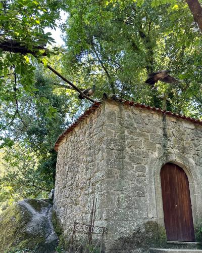 A small stone chapel among the trees of Parque do Fontelo in Viseu