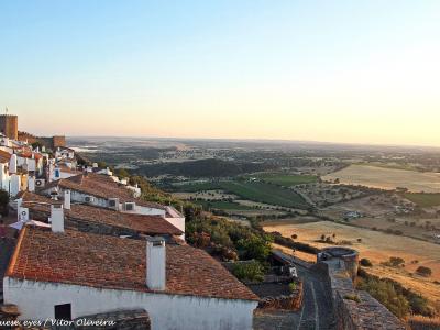 The whitewashed hilltop village of Monsaraz overlooking the Alentejo plains at sunset