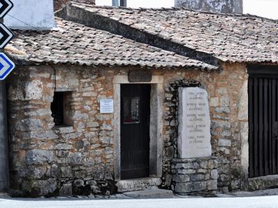 A stone shepherds' house with a memorial plaque in Aljustrel, Fátima