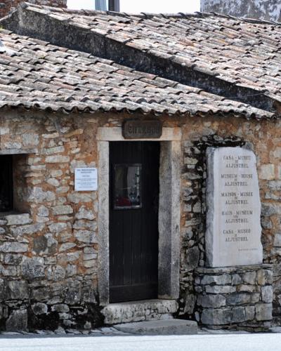 A stone shepherds' house with a memorial plaque in Aljustrel, Fátima