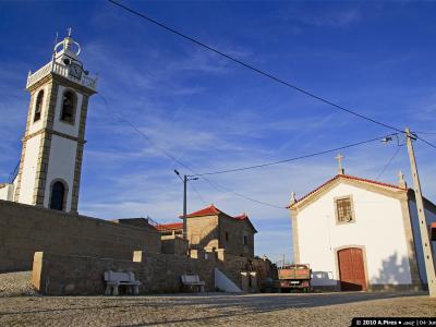 The whitewashed church and bell tower of Seixo do Côa under a blue sky