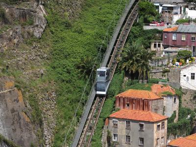 Funicular dos Guindais climbing the hillside below Porto's medieval walls