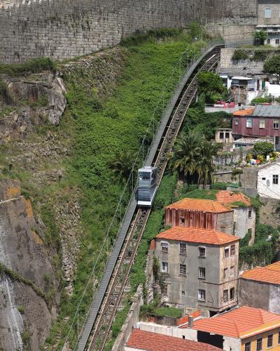 Funicular dos Guindais climbing the hillside below Porto's medieval walls