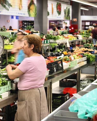 Vendor at a vegetable stall in Mercado do Bolhao market, Porto