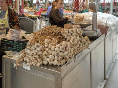 Produce stall piled with garlic inside Mercado do Bolhao, Porto