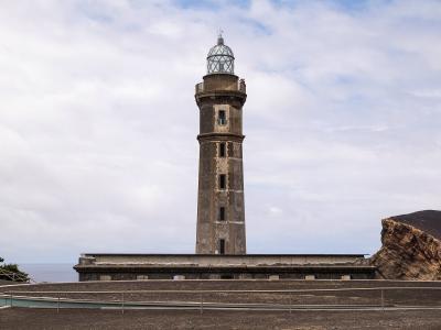 Ponta dos Capelinhos lighthouse beside the volcanic landscape of Faial Island, Azores