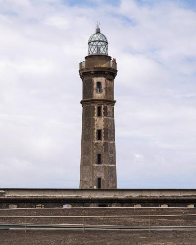 Ponta dos Capelinhos lighthouse beside the volcanic landscape of Faial Island, Azores