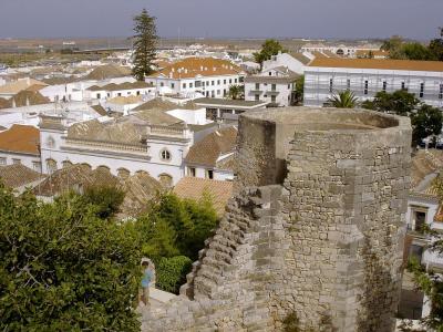 The walls of Tavira castle above the whitewashed rooftops of the town