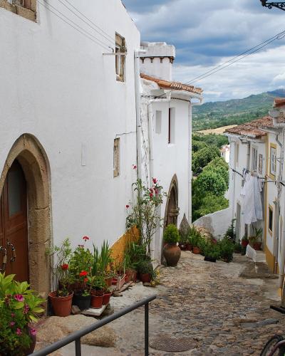Whitewashed steep lane with flowers in the Jewish quarter of Castelo de Vide