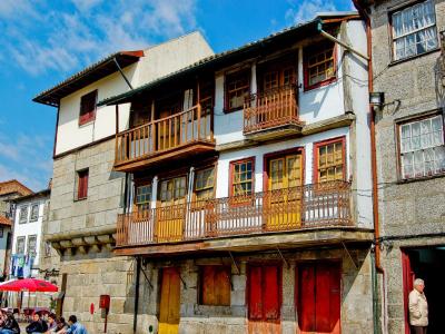 Historic houses with wooden balconies on Praca de Santiago, Guimaraes