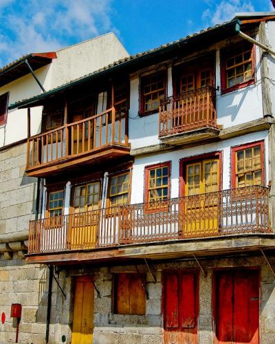 Historic houses with wooden balconies on Praca de Santiago, Guimaraes