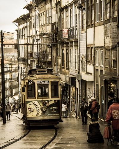 Historic tram climbing a street in Porto's old centre near Batalha, Portugal