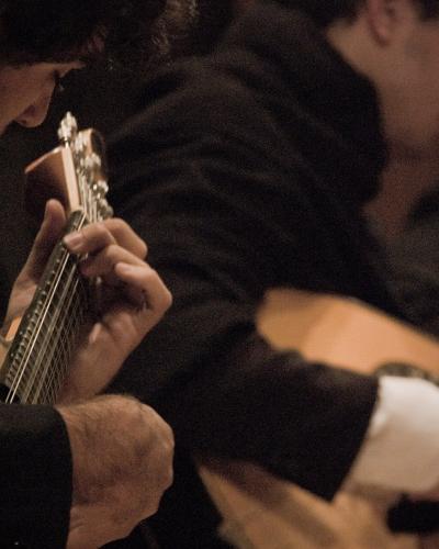 Musicians playing Portuguese guitars during a fado performance in Porto