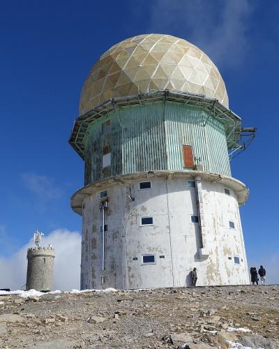 The domed radar towers at Torre, the summit of Serra da Estrela, under a blue sky