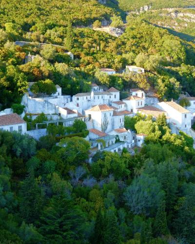 The white Convento da Arrábida on the wooded slopes of the Serra da Arrábida