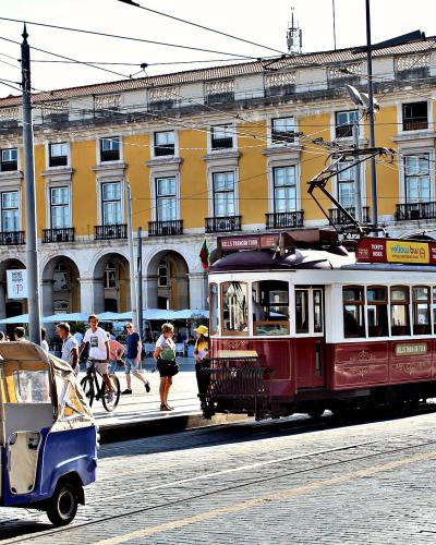 Tuk tuk and historic tram in Praca do Comercio, Lisbon